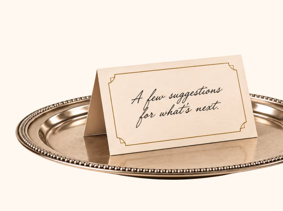 A silver tray holding a place card that reads “A few suggestions for what’s next.”